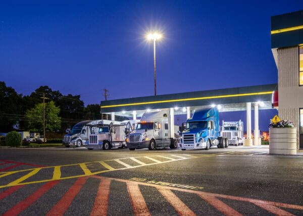 fleet of trucks at a fuel stop