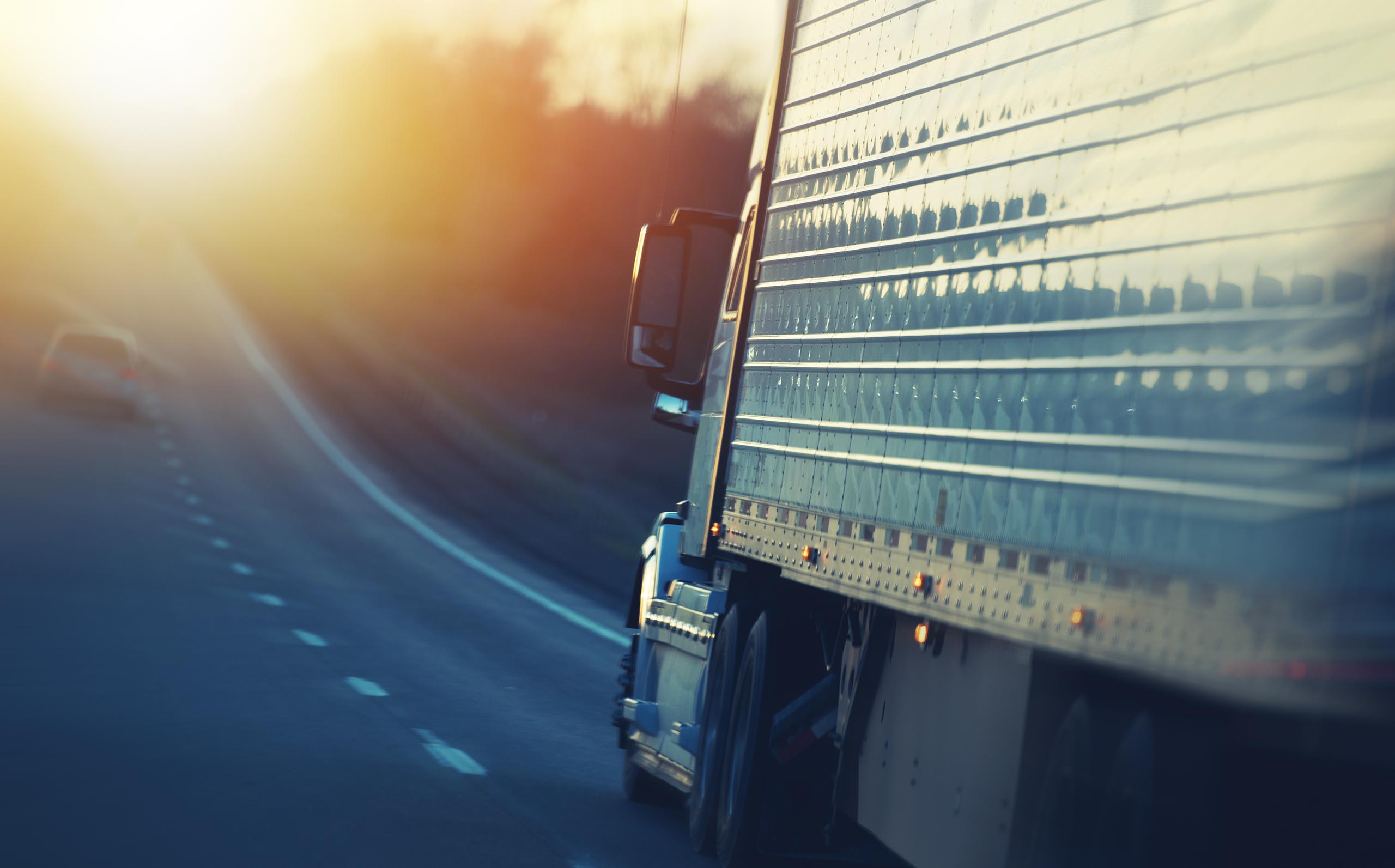 Truck driving down road